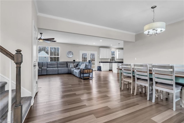 dining area with stairs, dark wood-type flooring, and ornamental molding