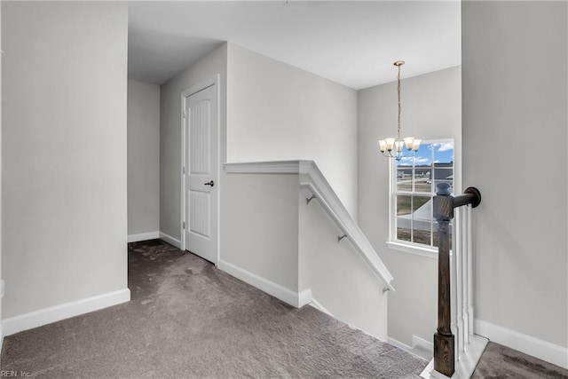 stairway featuring carpet, a notable chandelier, and baseboards