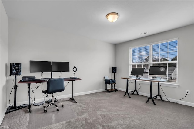 carpeted office space with visible vents and baseboards