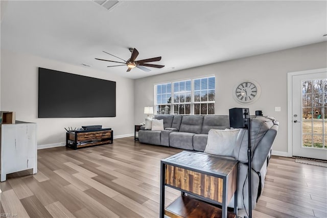 living area featuring ceiling fan, wood finished floors, and baseboards