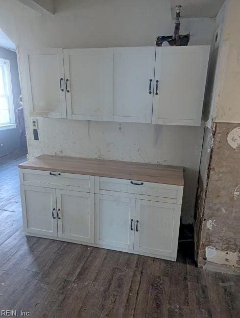 kitchen with wooden counters, white cabinets, and dark wood finished floors