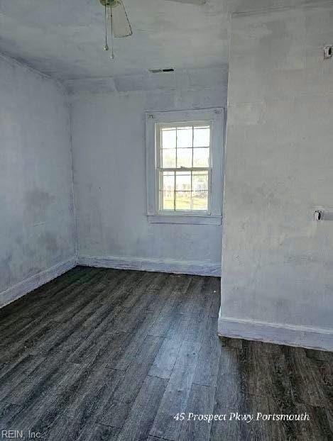 spare room featuring dark wood-style flooring