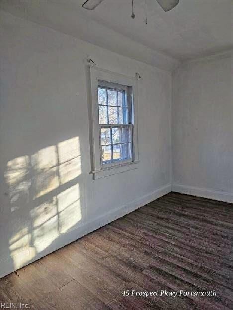 empty room with wood finished floors and baseboards