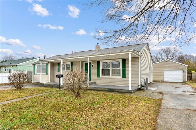 view of front of home featuring a garage, concrete driveway, a porch, an outbuilding, and a front lawn