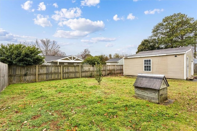 view of yard with a fenced backyard and an outdoor structure