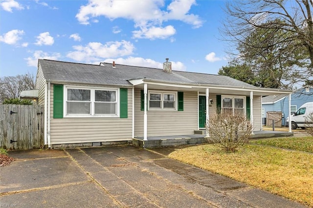 view of front of home featuring a front yard, fence, and a chimney