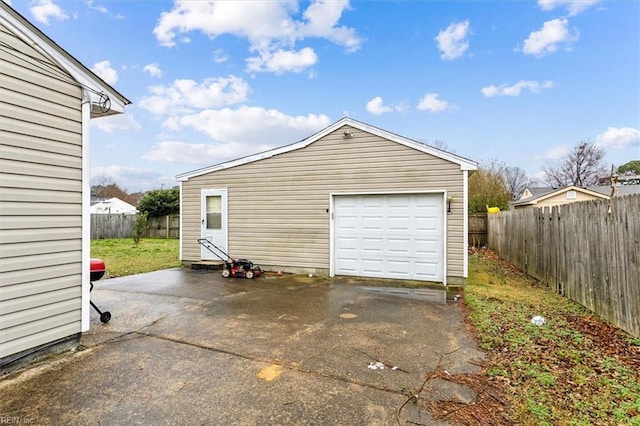 detached garage with driveway and fence