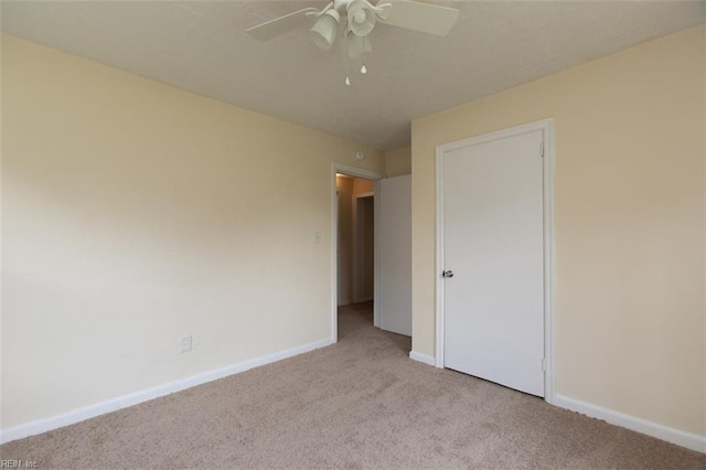 unfurnished bedroom with ceiling fan, carpet floors, and baseboards