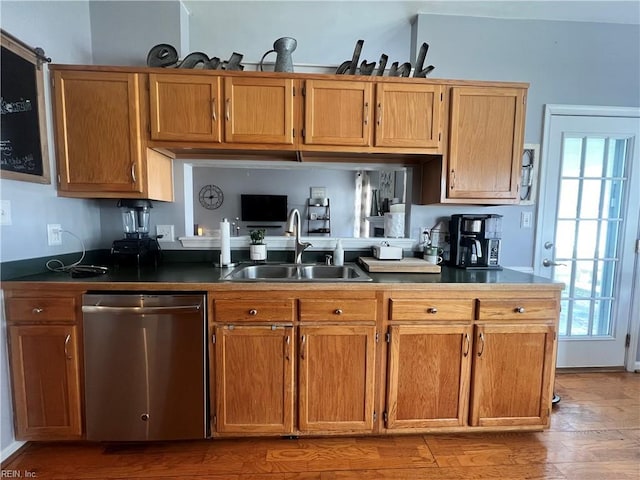 kitchen with a sink, stainless steel dishwasher, brown cabinetry, and light wood finished floors