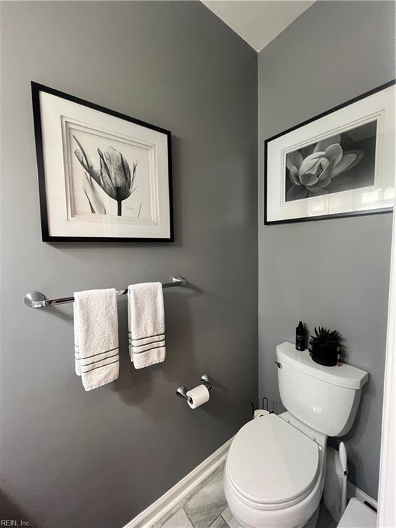 bathroom with baseboards and toilet