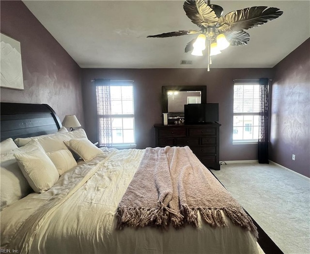 bedroom with visible vents, baseboards, carpet, and ceiling fan