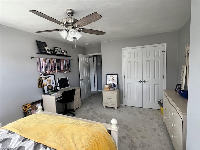 bedroom featuring a closet, light carpet, and a ceiling fan