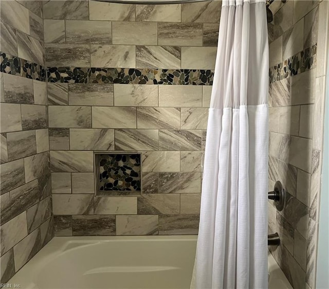 bathroom with shower / tub combo with curtain