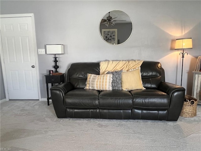 carpeted living room featuring ceiling fan