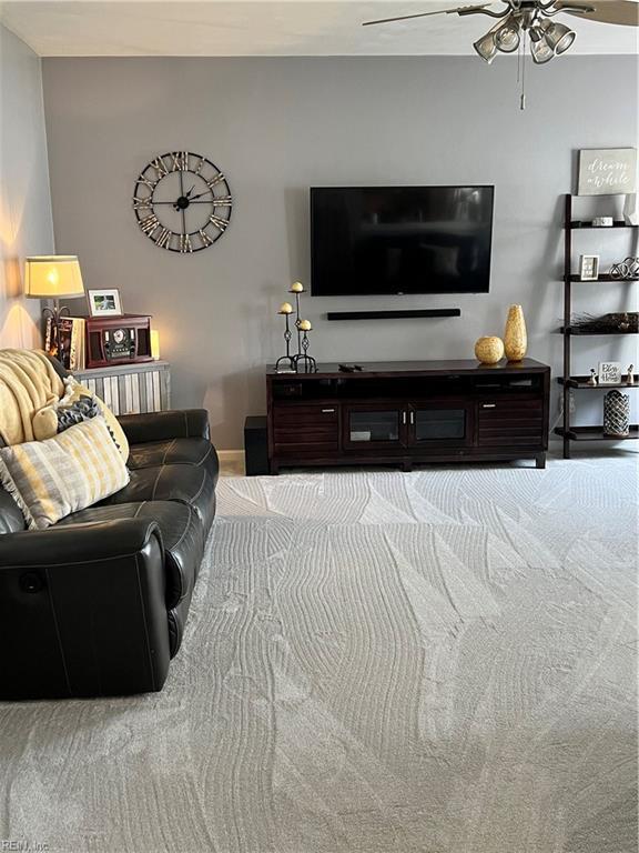 living room with carpet flooring and a ceiling fan