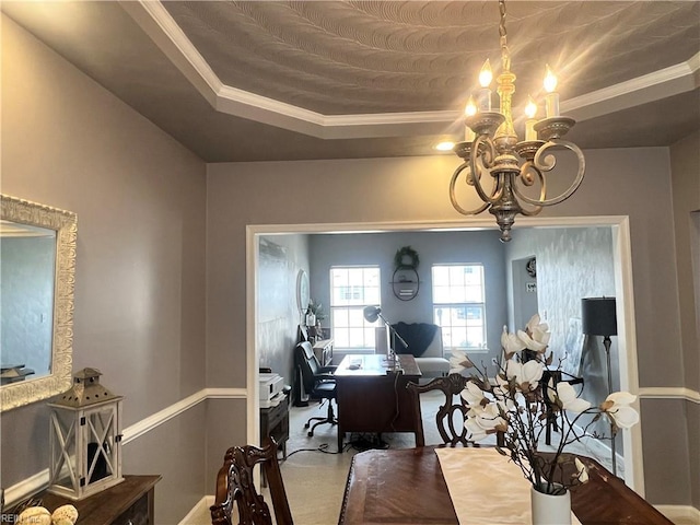 dining space with a tray ceiling, an inviting chandelier, and crown molding