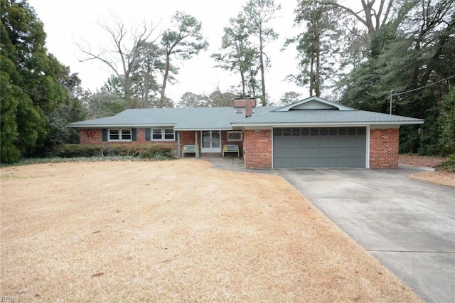 ranch-style house with driveway, brick siding, a chimney, and an attached garage