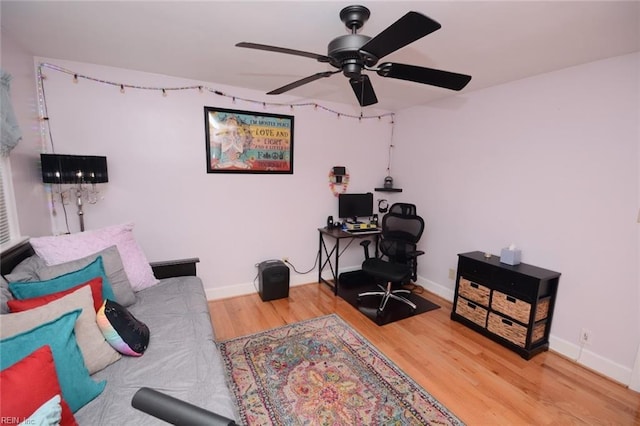 office area featuring wood finished floors, a ceiling fan, and baseboards