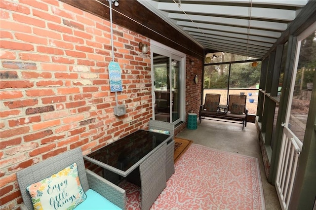 unfurnished sunroom with beam ceiling