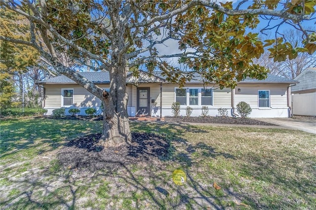 ranch-style house featuring fence and a front yard