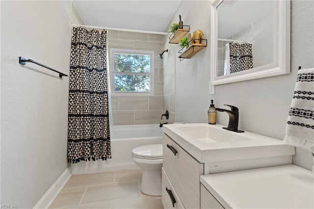 full bath featuring toilet, shower / bath combo, vanity, baseboards, and tile patterned floors