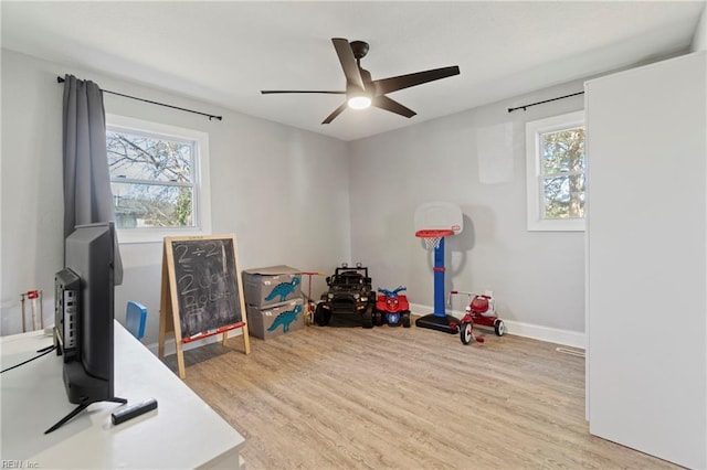 playroom featuring a wealth of natural light, baseboards, and wood finished floors