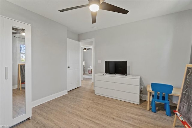 bedroom featuring ceiling fan, light wood-type flooring, and baseboards