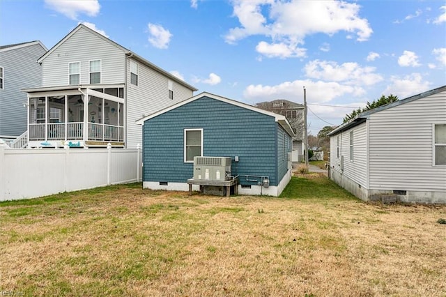 back of house with a sunroom, cooling unit, crawl space, and a lawn