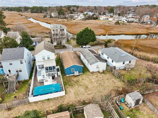 drone / aerial view with a water view and a residential view