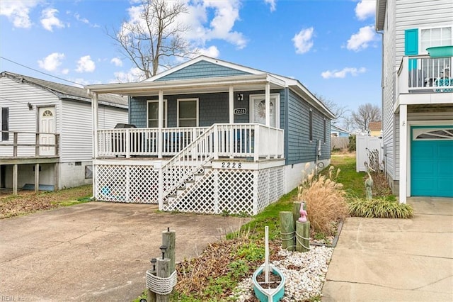 view of front of house featuring a garage, driveway, and a porch