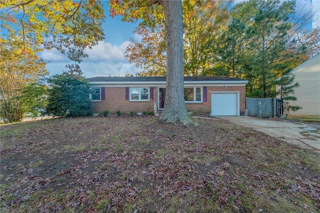 ranch-style house featuring a garage, fence, concrete driveway, and brick siding