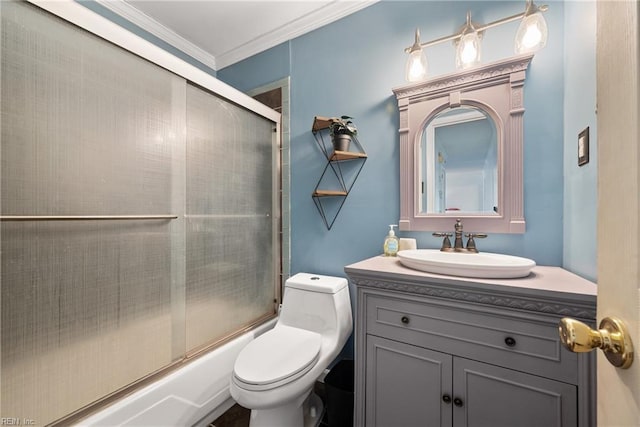 full bath featuring toilet, ornamental molding, bath / shower combo with glass door, and vanity