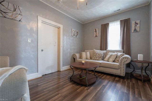 living area featuring visible vents, crown molding, baseboards, and wood finished floors