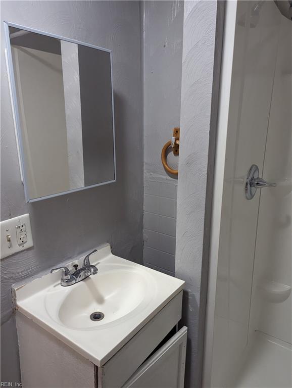 bathroom with vanity and walk in shower