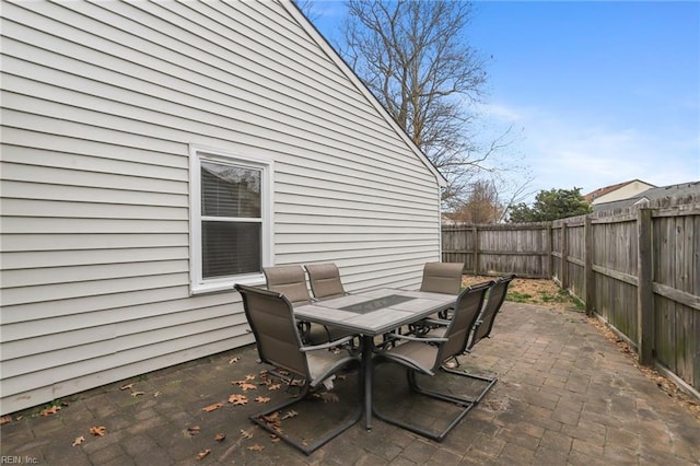 view of patio with outdoor dining space and a fenced backyard