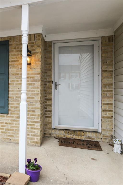 entrance to property with brick siding