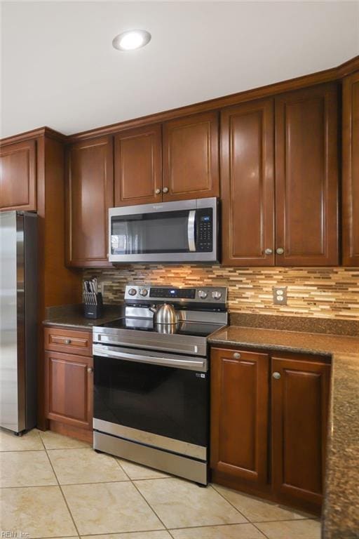 kitchen with light tile patterned floors, stainless steel appliances, tasteful backsplash, and recessed lighting