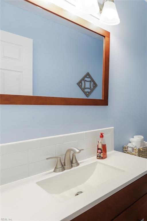 bathroom with tasteful backsplash and vanity