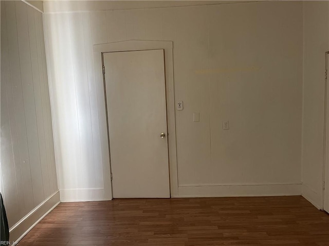 spare room with wood finished floors