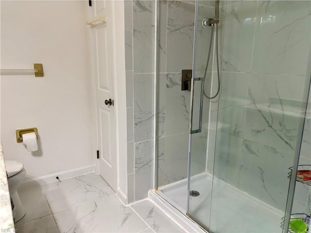 bathroom with toilet, marble finish floor, a marble finish shower, and baseboards