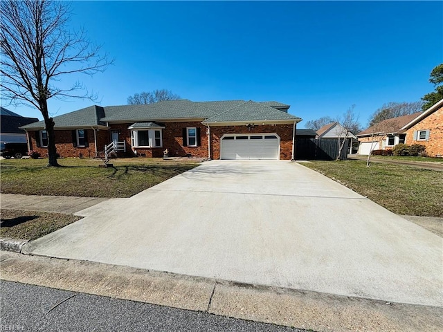 ranch-style house featuring a garage, driveway, brick siding, fence, and a front yard