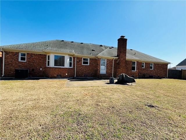 rear view of house featuring a patio, crawl space, a yard, central air condition unit, and brick siding