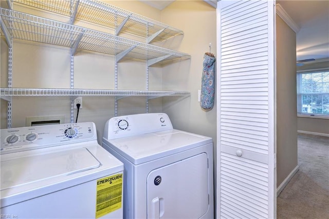 laundry room featuring carpet, laundry area, baseboards, and separate washer and dryer