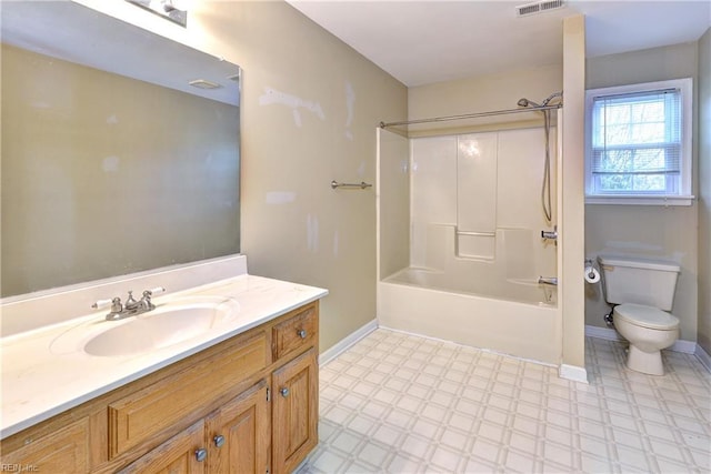 bathroom featuring bathing tub / shower combination, toilet, vanity, baseboards, and tile patterned floors