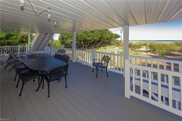 view of patio featuring a deck, outdoor dining space, and stairs