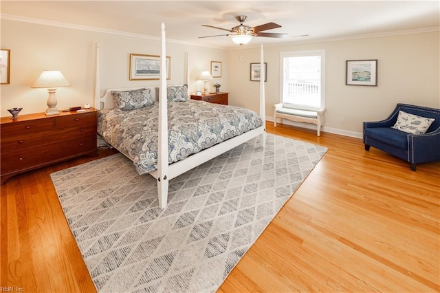 bedroom featuring baseboards, ornamental molding, and wood finished floors