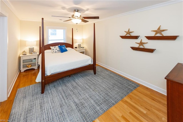 bedroom with ornamental molding, wood finished floors, and baseboards