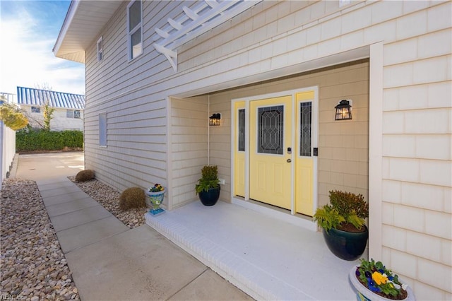 view of exterior entry with fence