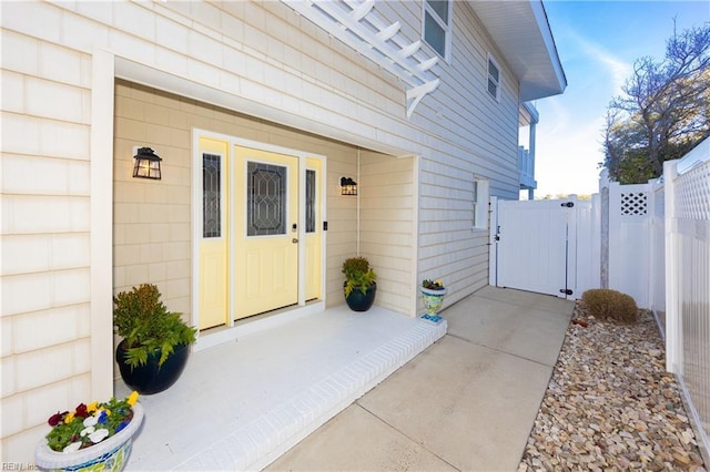 doorway to property featuring a gate and fence