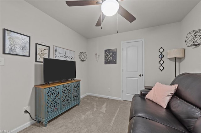 living room with carpet, baseboards, and ceiling fan